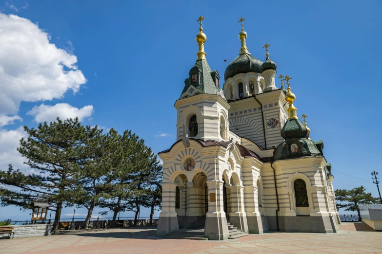 a very tall white and grey church building with some windows