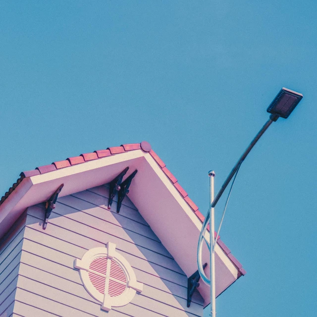 two birds sitting on top of the roof of a building