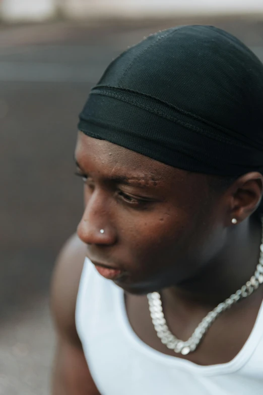 a young woman wearing a pearl necklace around her ear