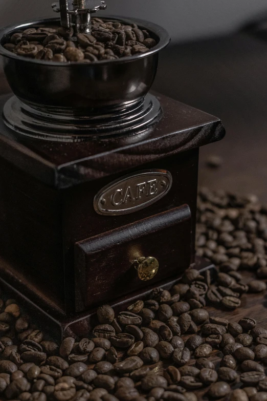 a coffee grinder that is on top of some beans