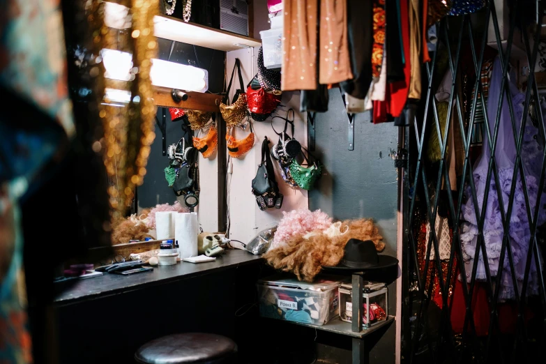 an area with many clothing hanging on the wall