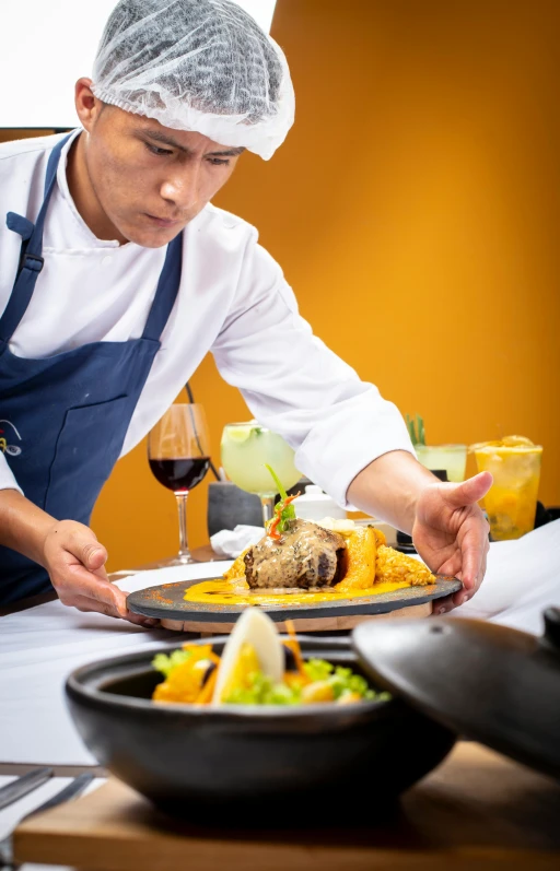 a person with an apron and hat serving food