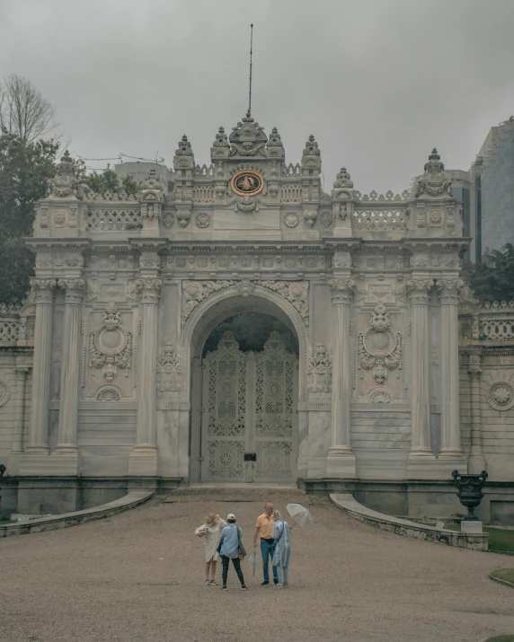 three people standing in front of a very large building