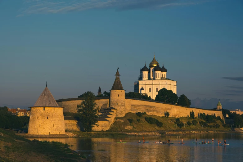 a castle on the water with people in it