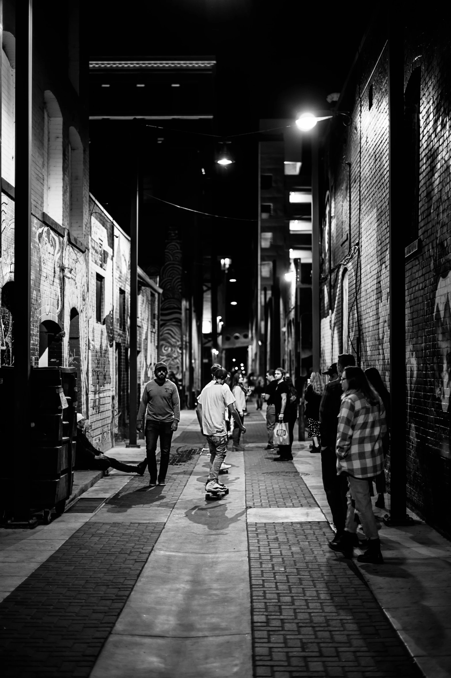 several people walking on a alley way at night