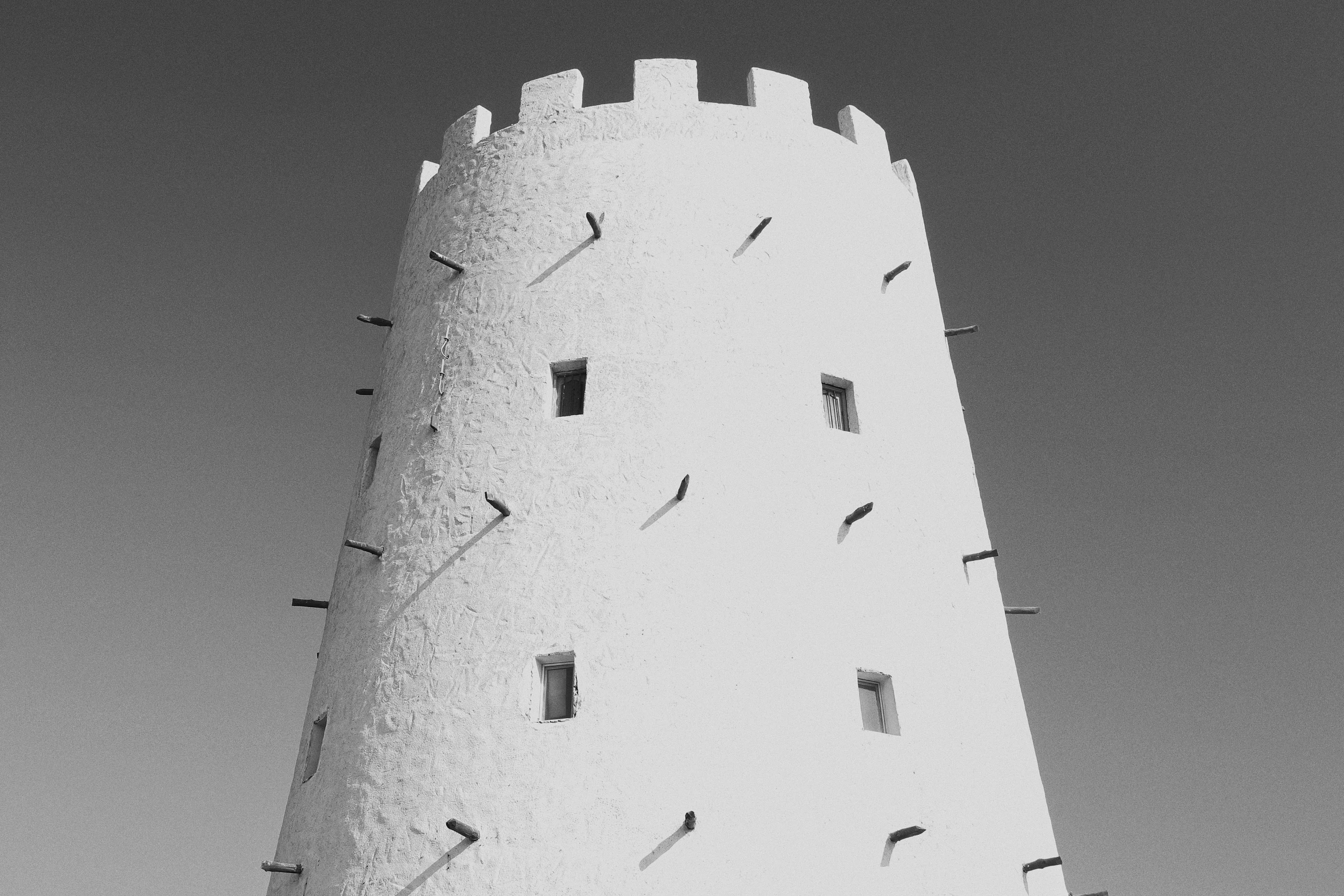 black and white pograph of a lighthouse tower with clock