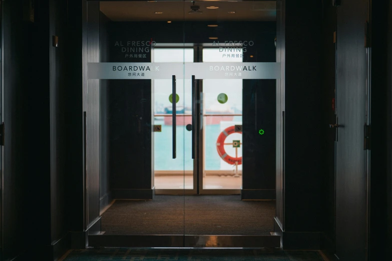 this is an elevator with glass doors leading to a boarding room