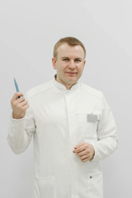 a man in white shirt holding a knife