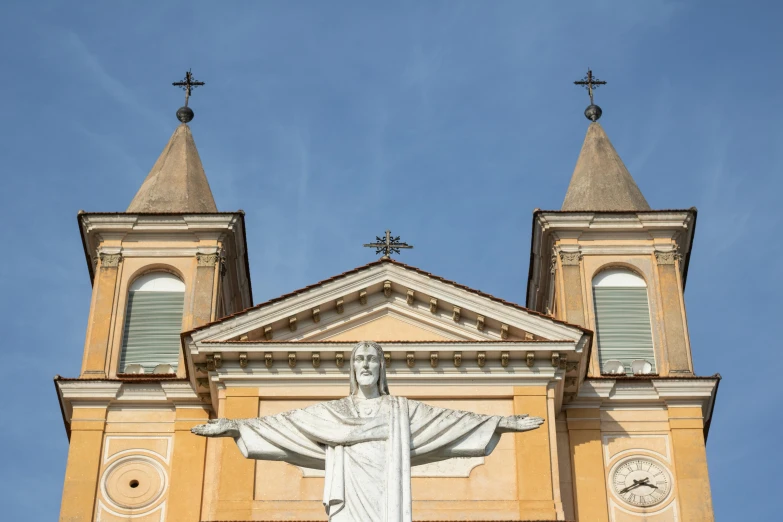 a church with a statue of jesus on top of it