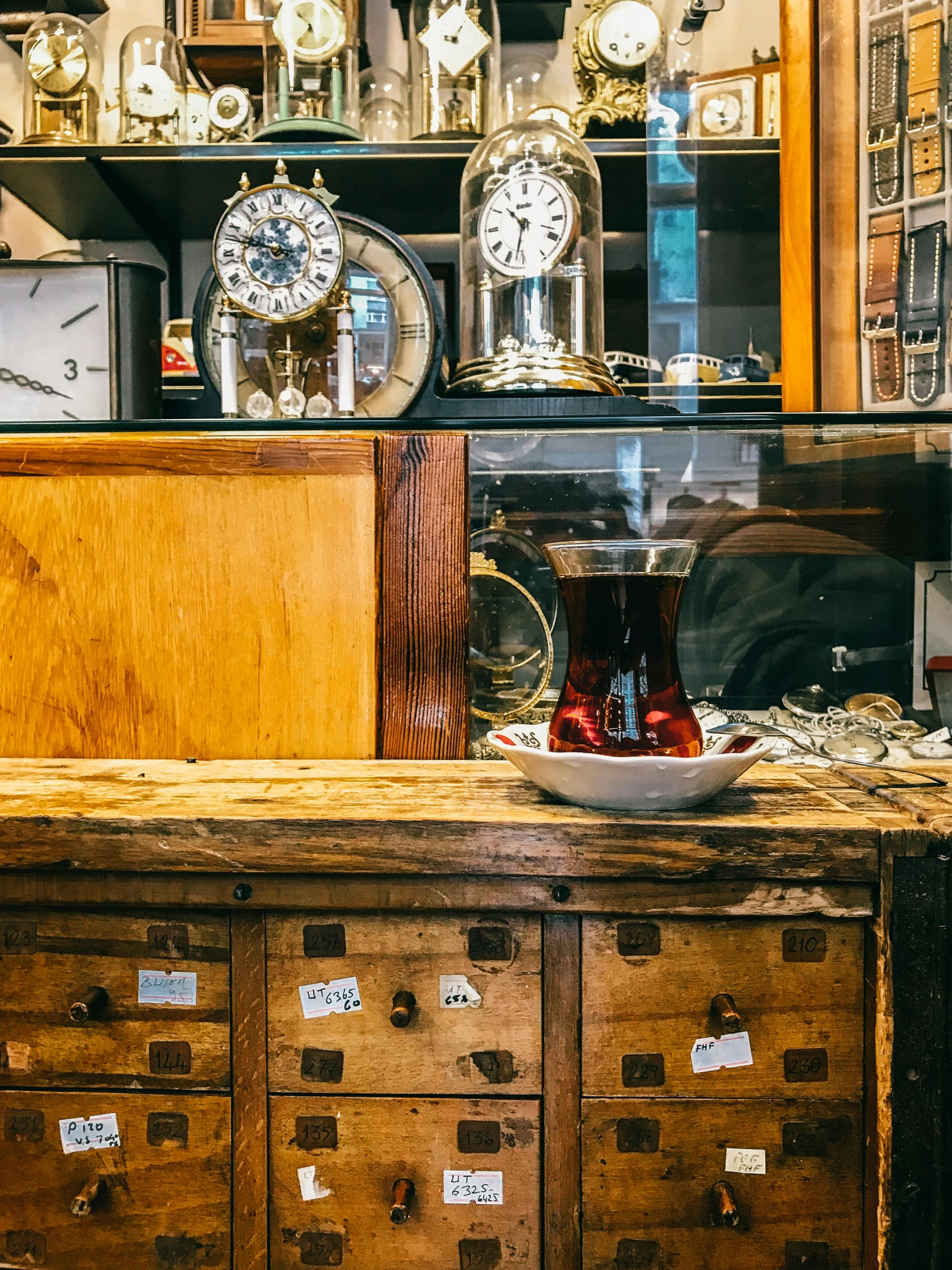 a lot of clocks sitting on top of a dresser