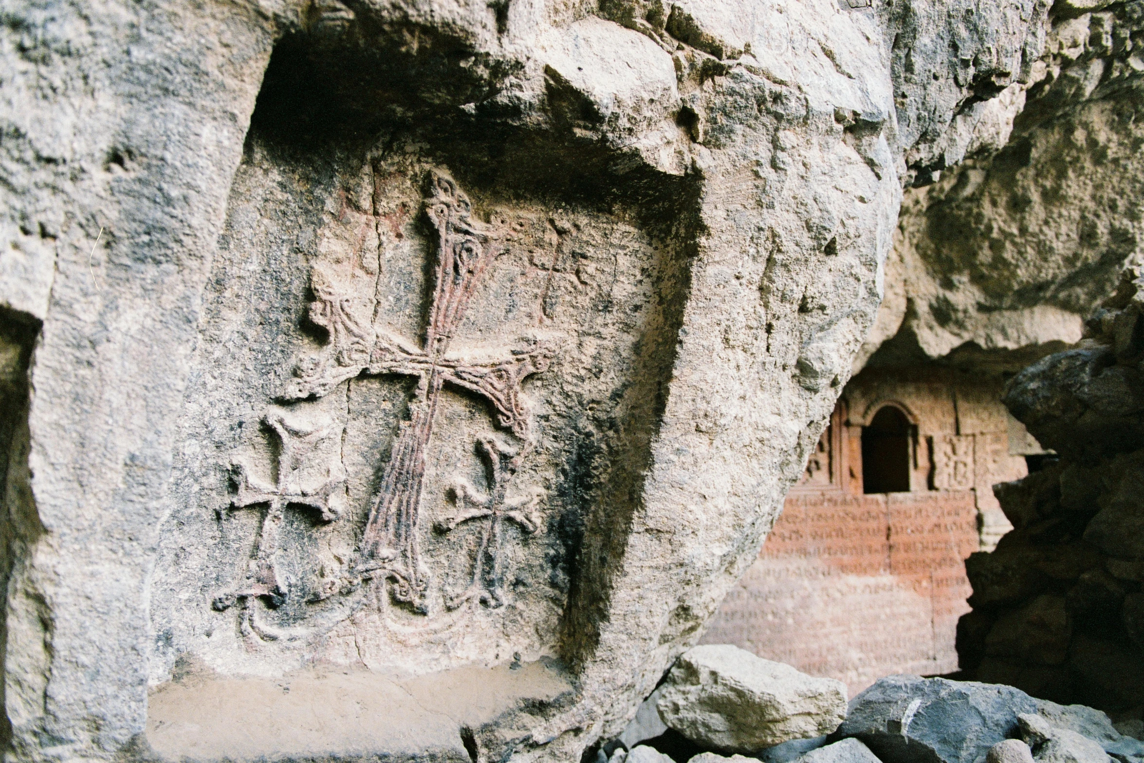 a man is taking a po of carvings in the rocks