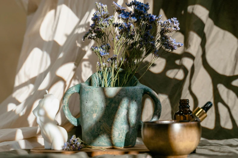 vases with lavender plants on top and bottles beside