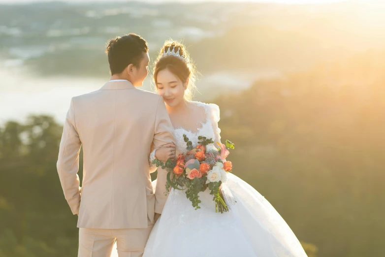 newlywed couple at sunset looking down at the ground