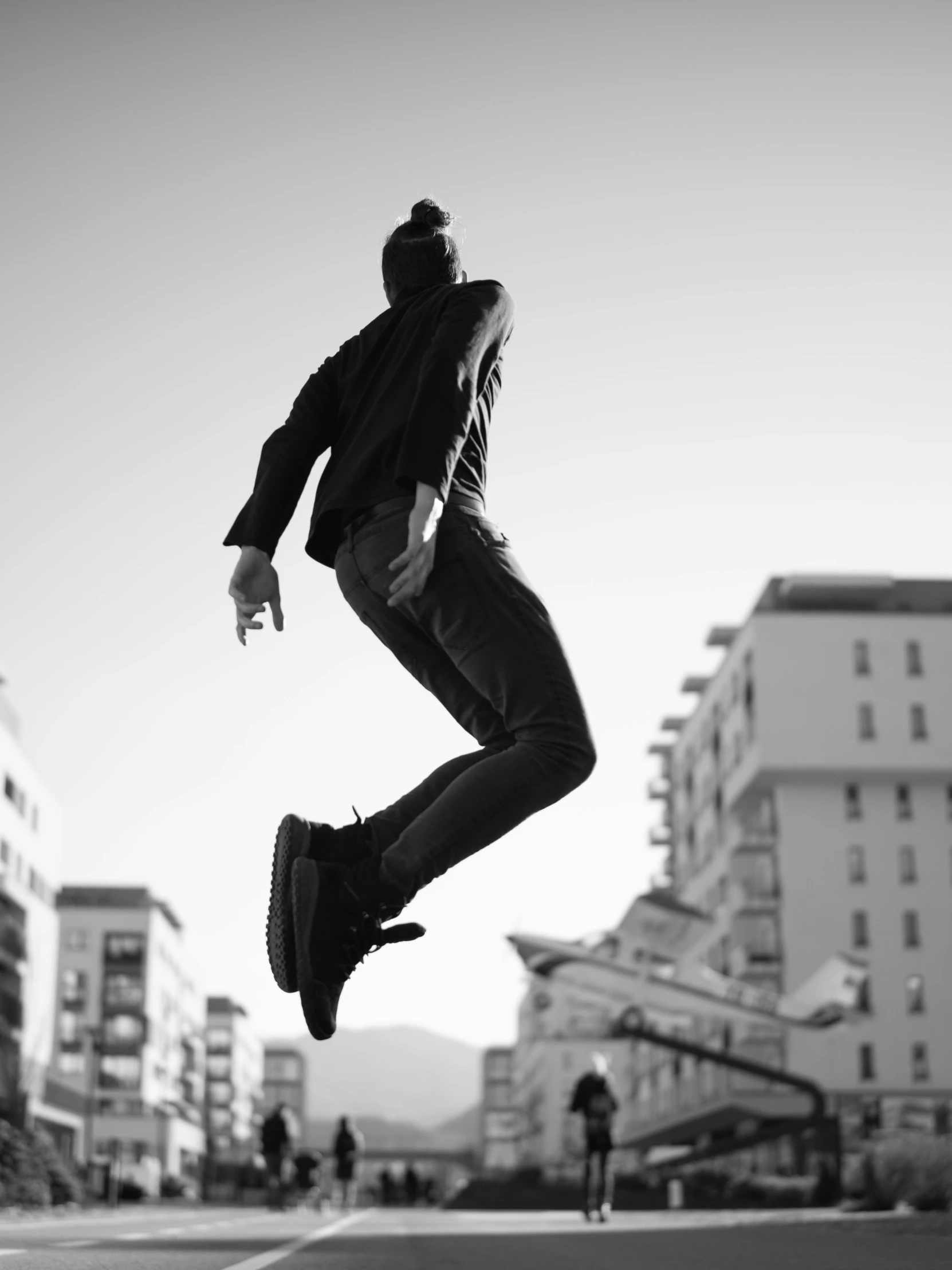 a skateboarder in mid air on an urban surface