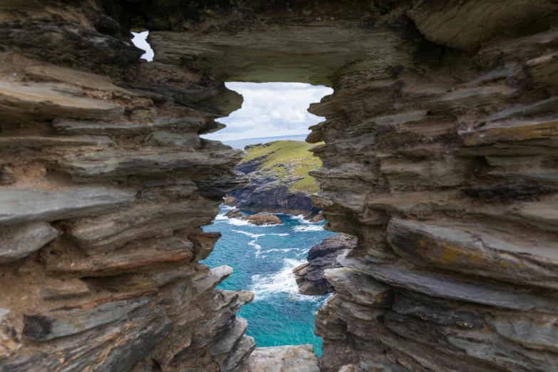 a narrow stone path crosses the ocean in a coastal landscape