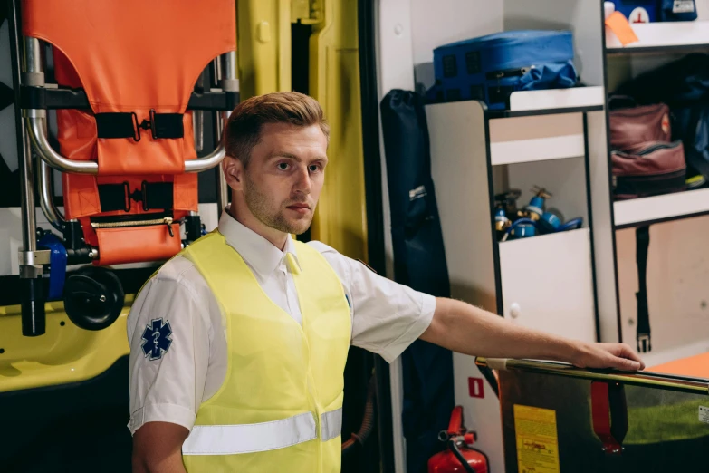 a man in a yellow vest is holding a rail