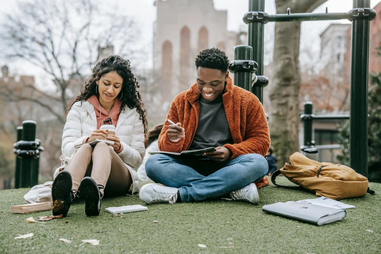 two people on a grassy field sitting down