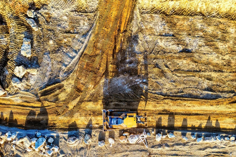 a yellow vehicle sitting next to another yellow tractor