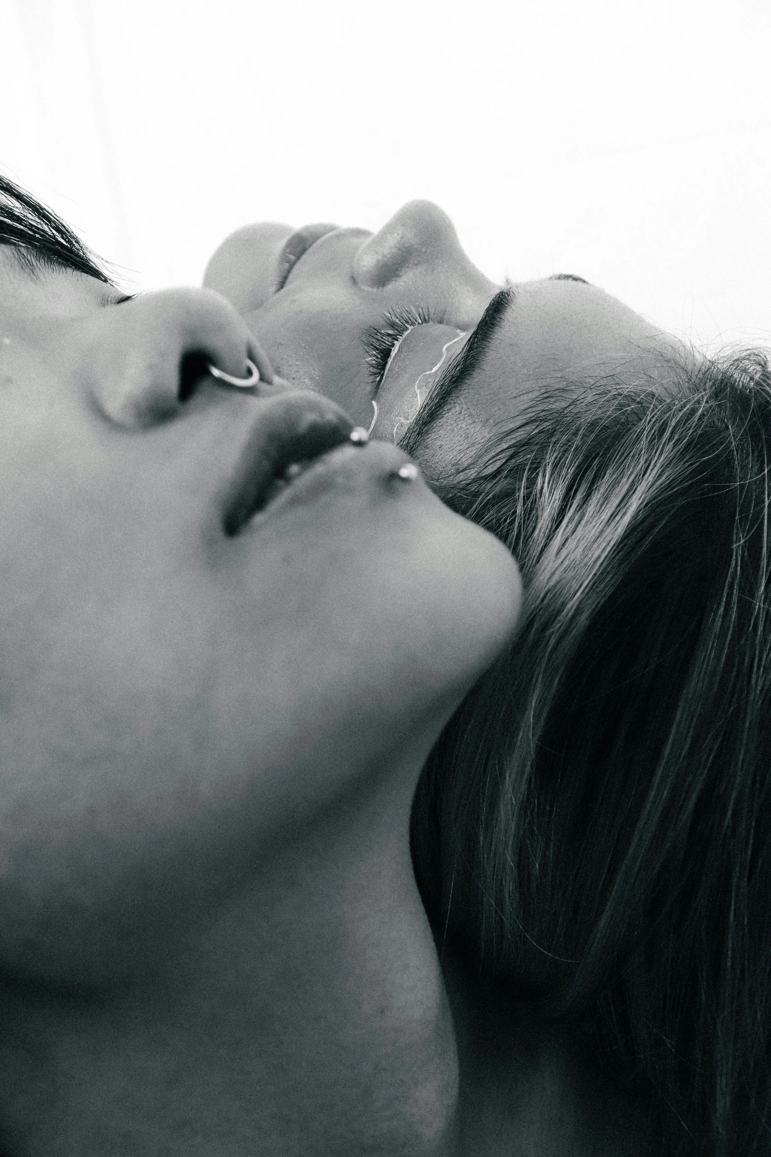 black and white po of a woman kissing another woman