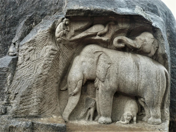 three elephants have carved into the stone wall