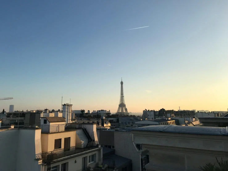 view of the eiffel tower from a roof at dusk