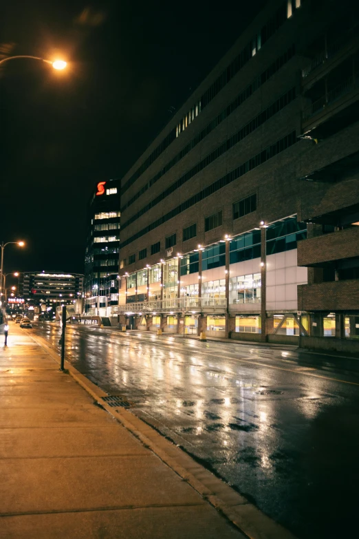 a city street with cars and buildings at night