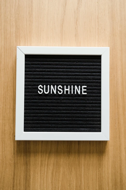 the words sunshine are printed on a piece of wood