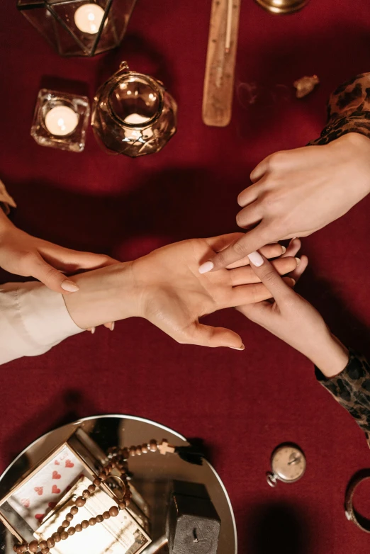 hands of people on the table holding each other