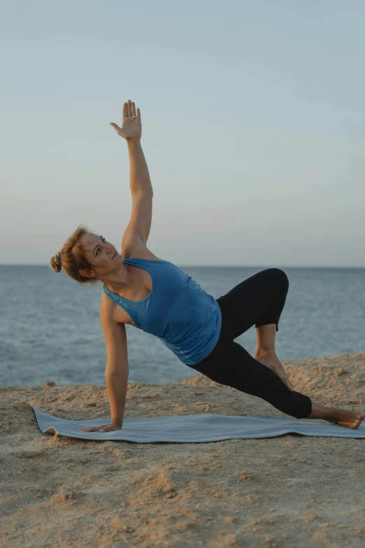 a woman practices the seated hand and shoulder yoga pose