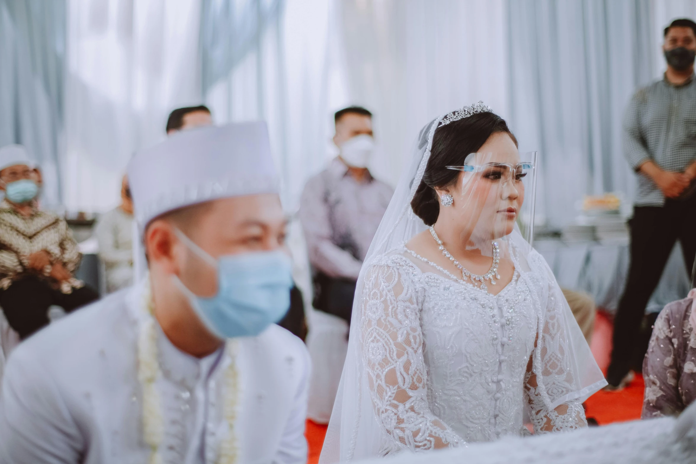 the bride and groom wear protective masks for a wedding ceremony