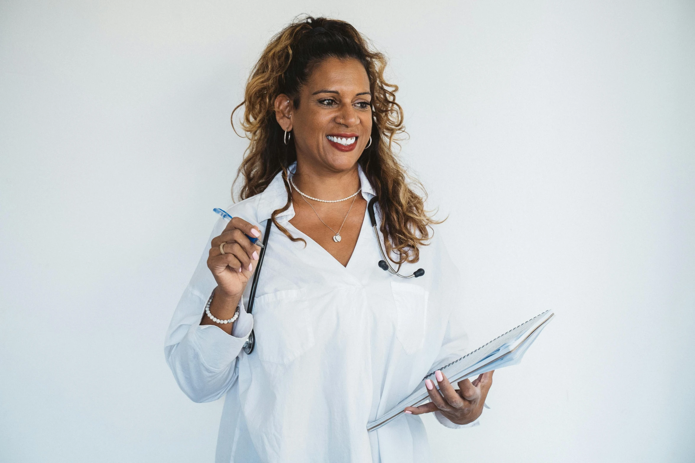 a young woman is holding a clipboard and smiling