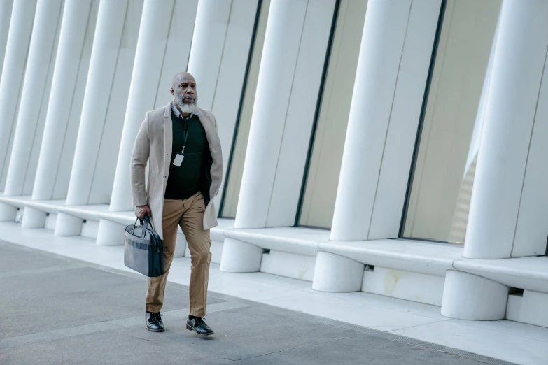 a man with white hair stands on the side of a pillar