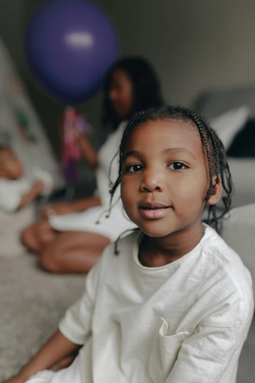  smiling at camera with balloon in background