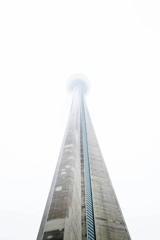 a view of a tall building in the sky with some clouds