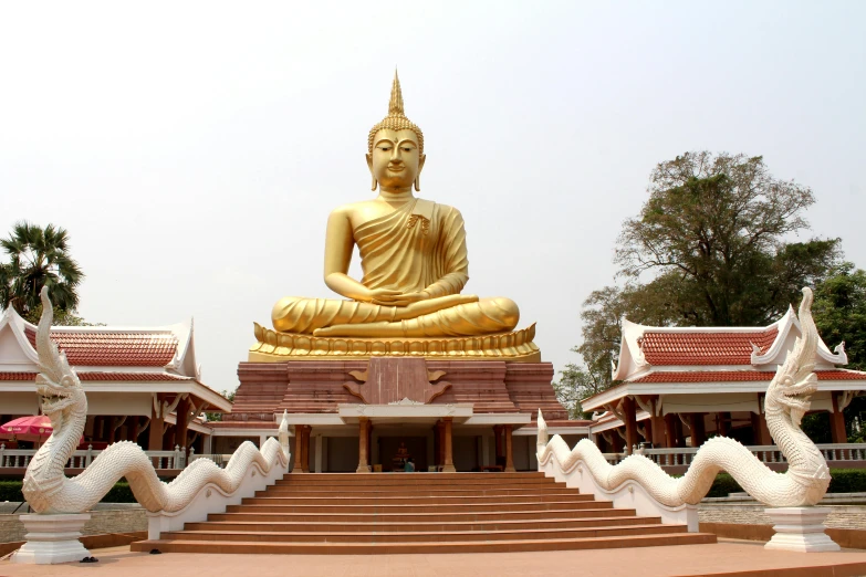the large buddha statue is placed on top of a stairway