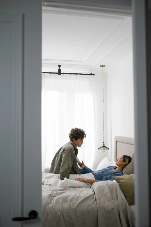 a  and a young woman laying in bed