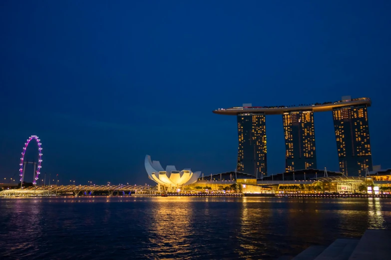 the oriental ferris wheel sits in front of some very tall buildings