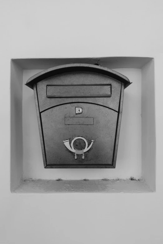 a large mailbox on the wall above it is a sign