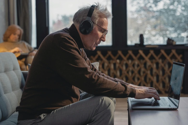 a man sitting in front of a laptop computer