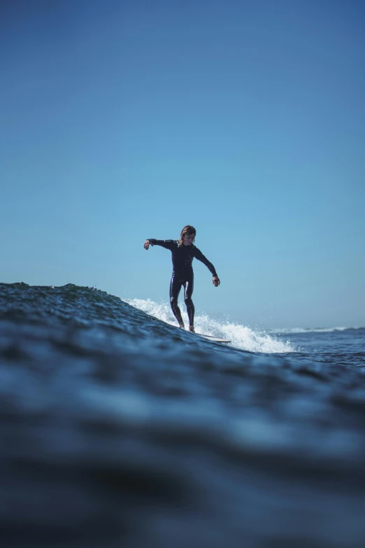 the surfer is catching a wave while riding his board