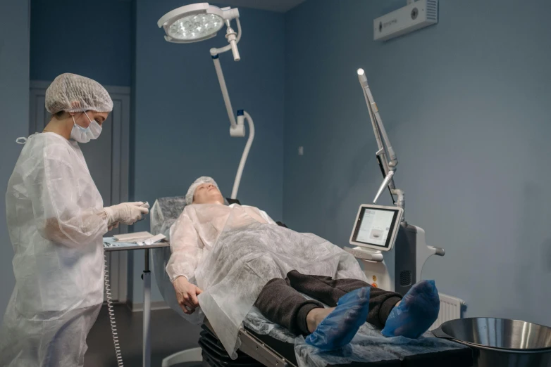 a woman is laying in an operating chair while getting her  examined