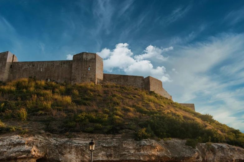 a very large stone castle on top of a hill