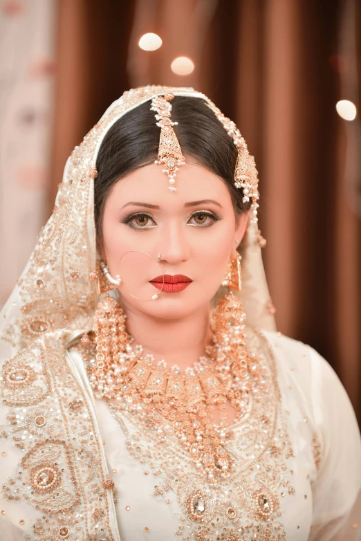 a beautiful bride posing with her wedding outfit on