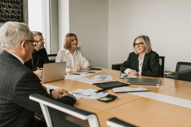 a group of people sitting around a conference table