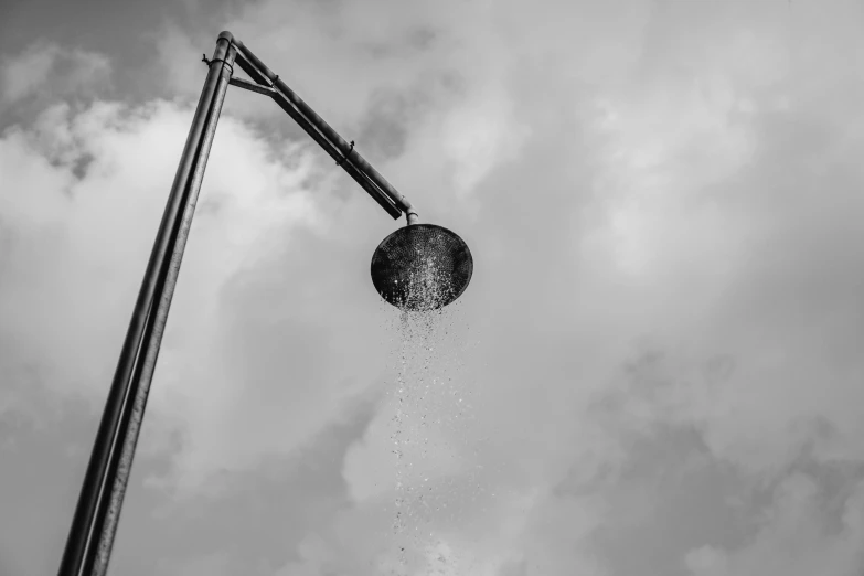 the water is splashing out of the street lamp