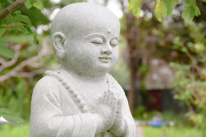 a statue sitting in the middle of grass