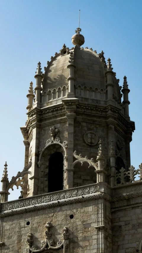 the clock tower is made of stone and has intricate carvings