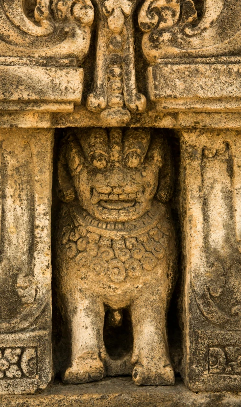 an animal carved into the stone of a temple