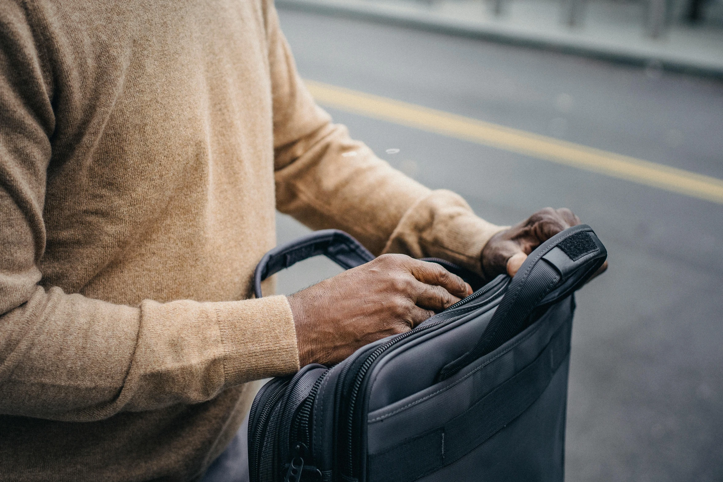 an older man is holding his briefcase in his hands