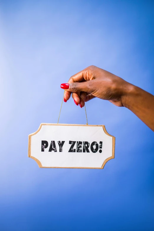 a person is holding up a sign that says pay zero